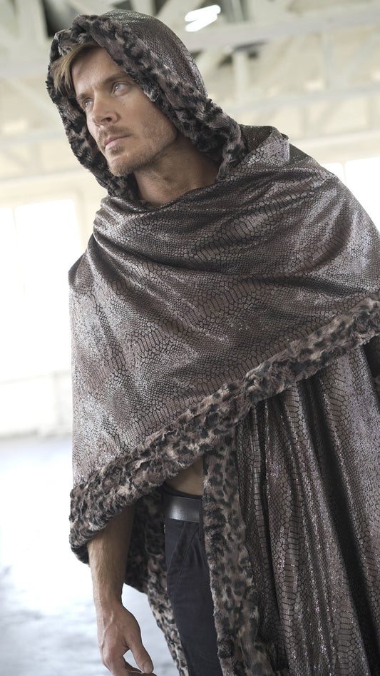 A man wearing a steampunk-style faux fur poncho in brown with a leopard print pattern, hooded, and draped over his shoulders.