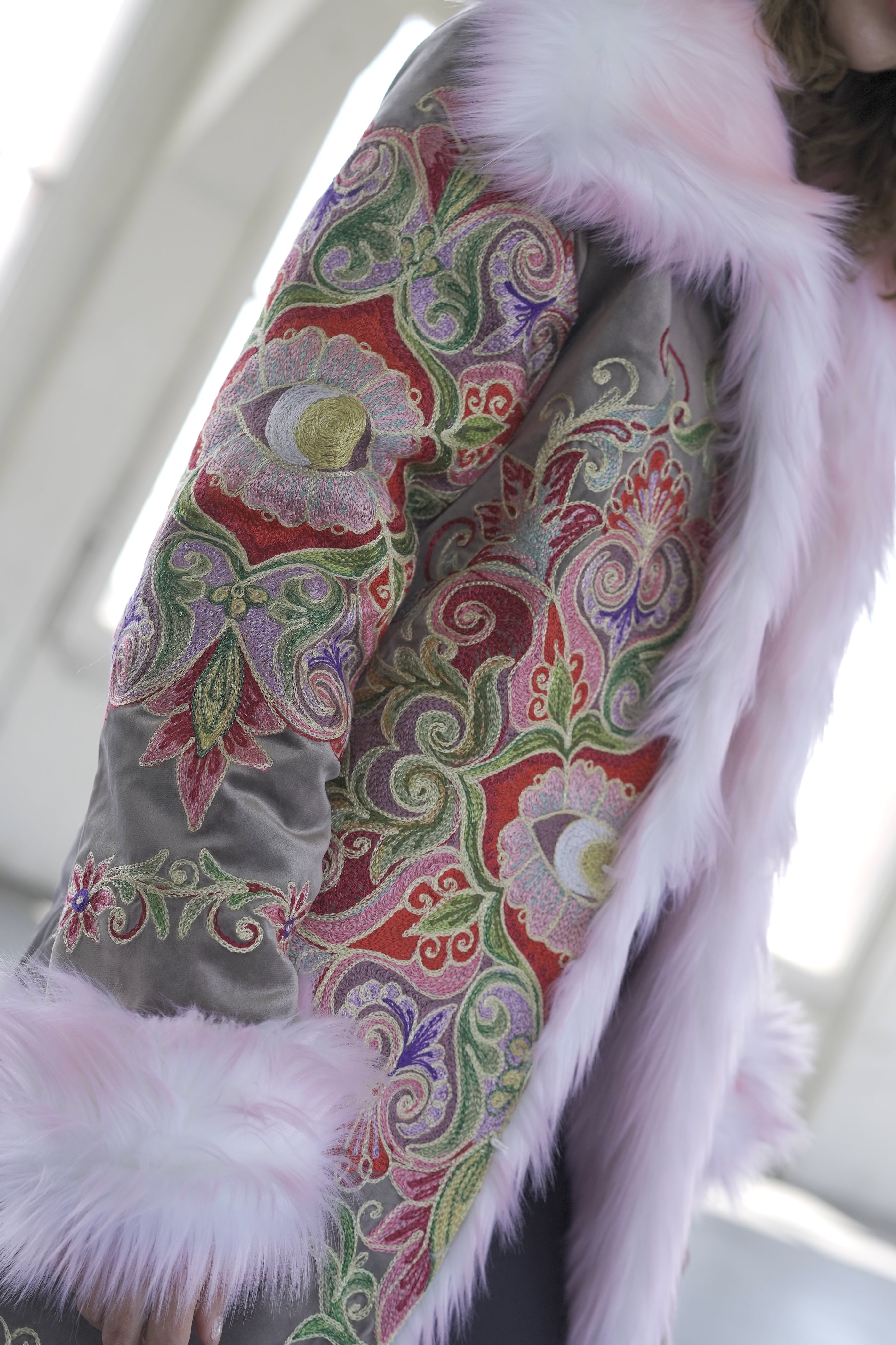 Close-up of colorful floral embroidery on Red Flower reversible faux fur festival coat