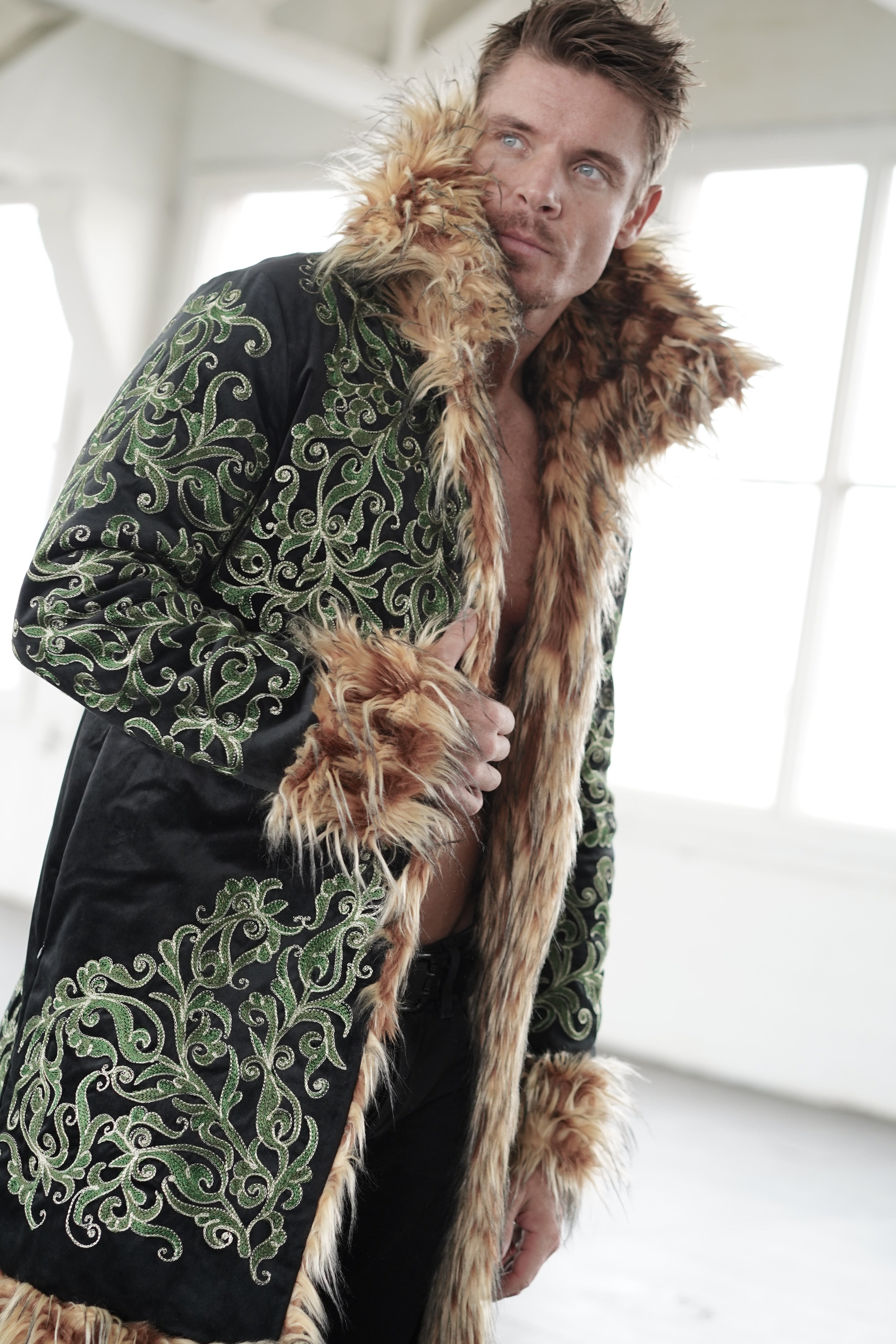 Men's embroidered festival coat with black and green Tree of Life design and brown faux fur trim